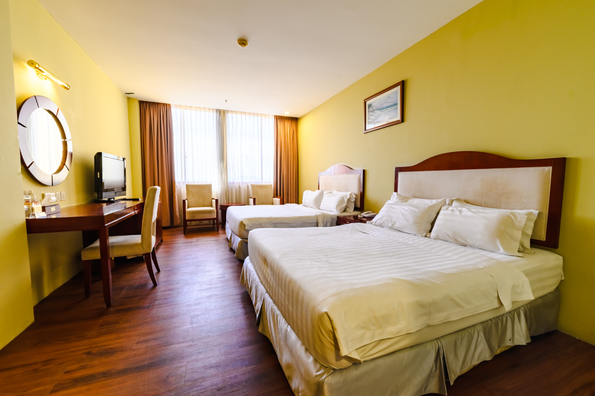 Spacious Family Room at Gaya Centre Hotel with two queen beds and city or sea view